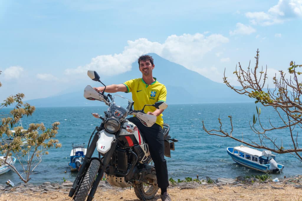 Me on a moto at the lake atitlan with the volcano Atitlan in the background