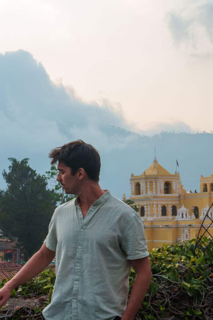Me posing for the photo on a rooftop in Antigua. We can see the church la merced in the background.