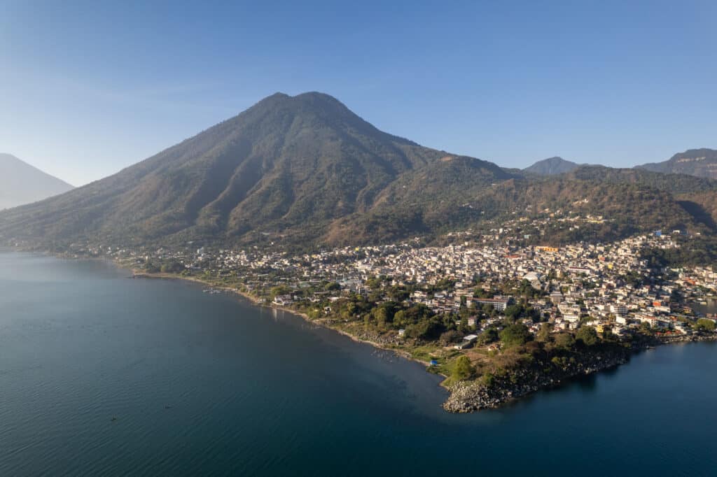 aerial view of san Pedro Pedro city and San PEdro Volcano in the backgorund, with the lake atitlan in the foreground. This is in Guatemala.