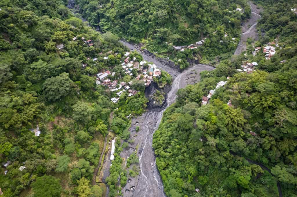 aerial view of a river with small village nearby where worker live to be close to the emerald mines