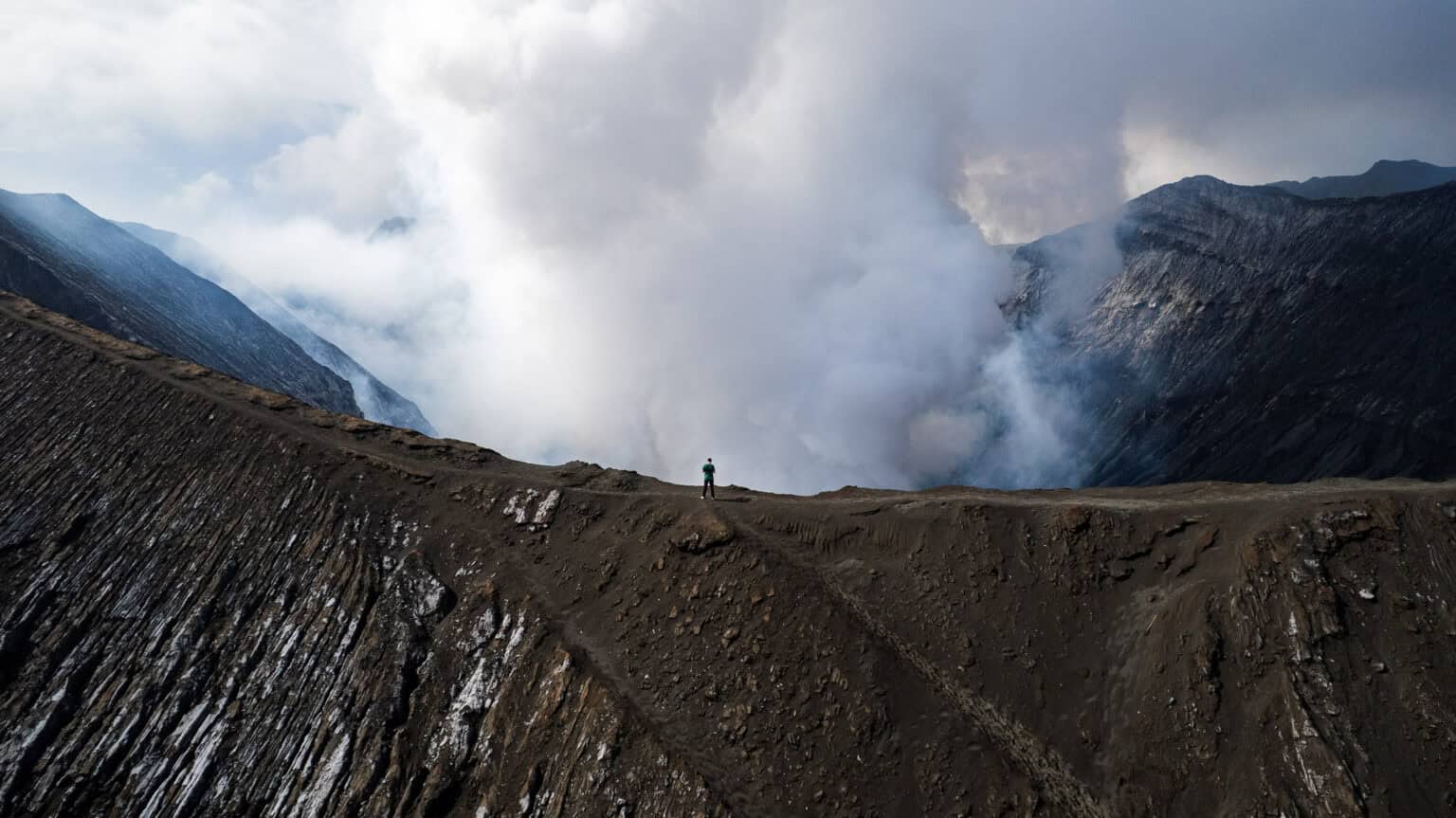 me on the crater that shows the huge dimension of the Bromo volcano, Java Indonesia