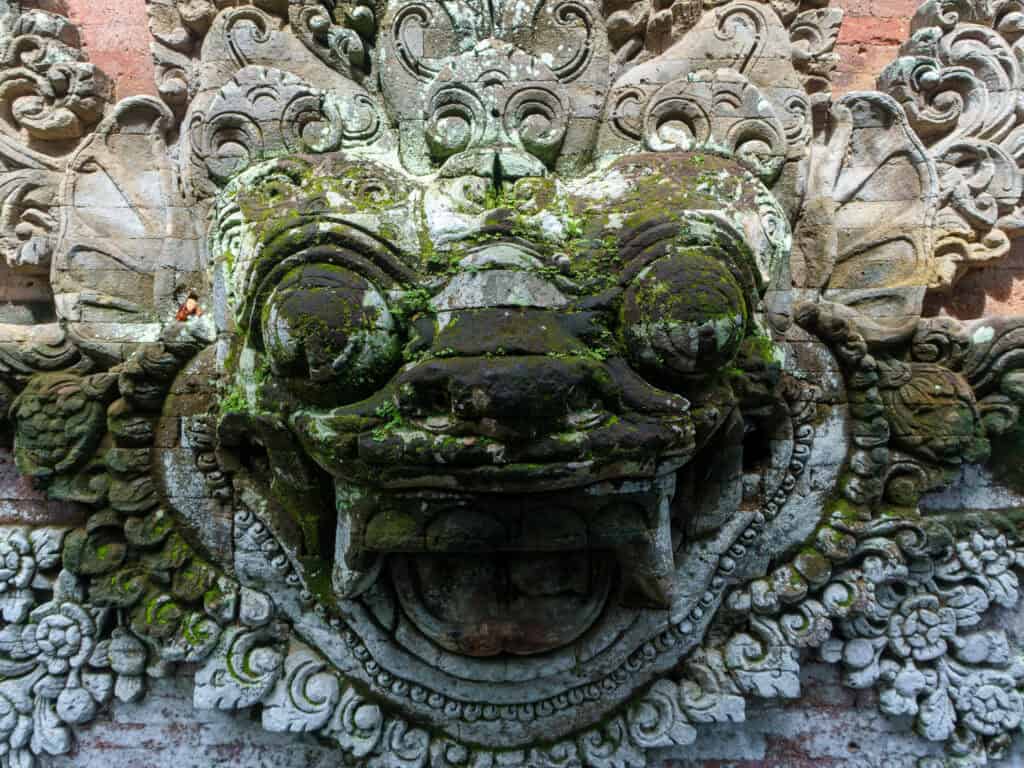 Close-up of bali temple statue that looks like demons