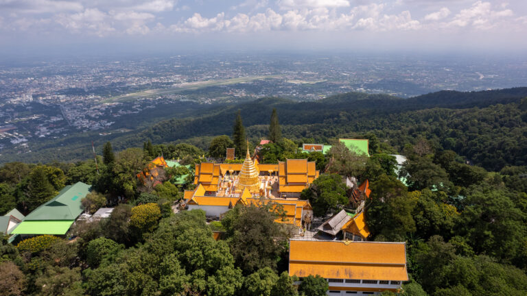 Aerial view of the Doi Suthep temple situated on a hill close to Chaing Mai in Thailand that we see in the background.