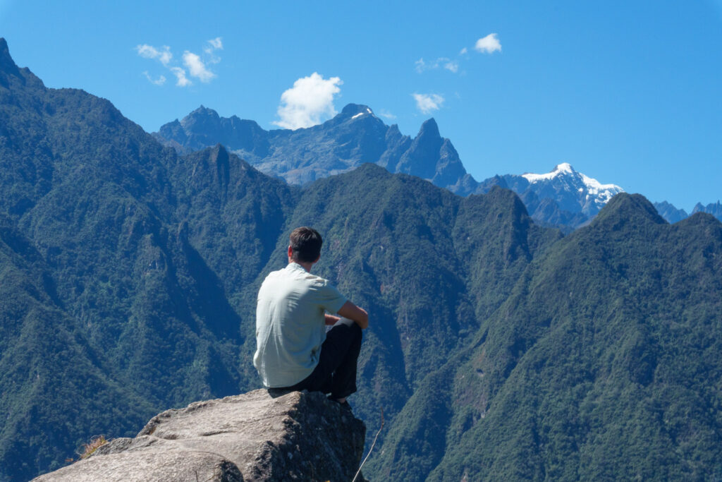 Me at the top of Huayna Picchu at the machu picchu ruins in Peru, contemplating the mountain ladnscape