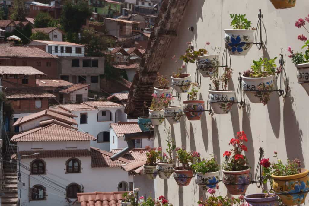 Streets in Cusco with flowers attached on the wall