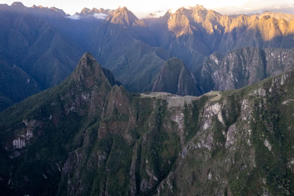 Aerial view of the Machu Picchu archeological site with its surroundings mountains, like the huayna picchu, the machu picchu and many more