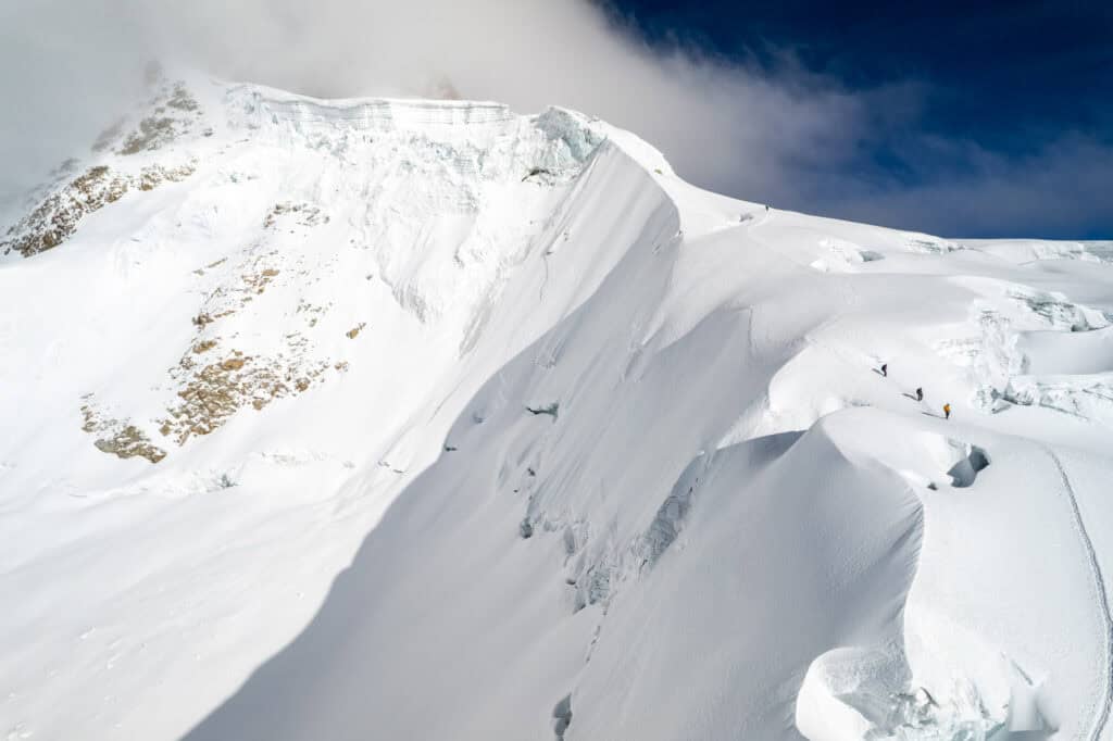 Three alpinist going down the Huayna Potosi