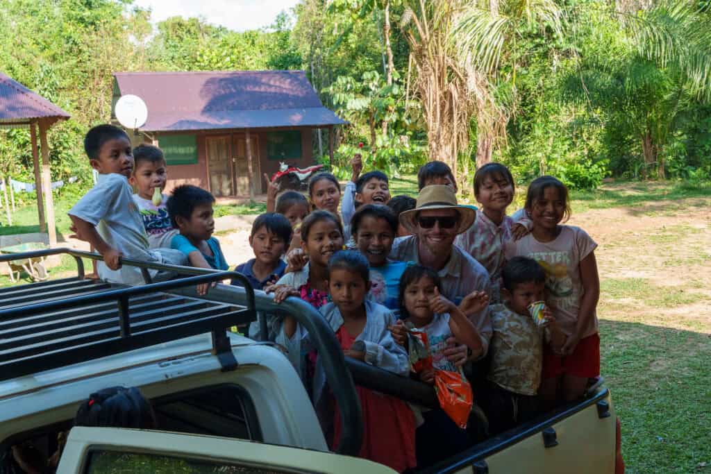 Erik, the founder of sustainable Bolivia and children from Warnes. there are all at the back of a pick-up to bring them back to Warnes village after visiting Sustainalbe Bolivia site.