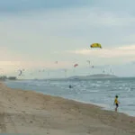 twenty or more poeple are doing kitesurf at the same time on Prea beach in the north of Brazil.