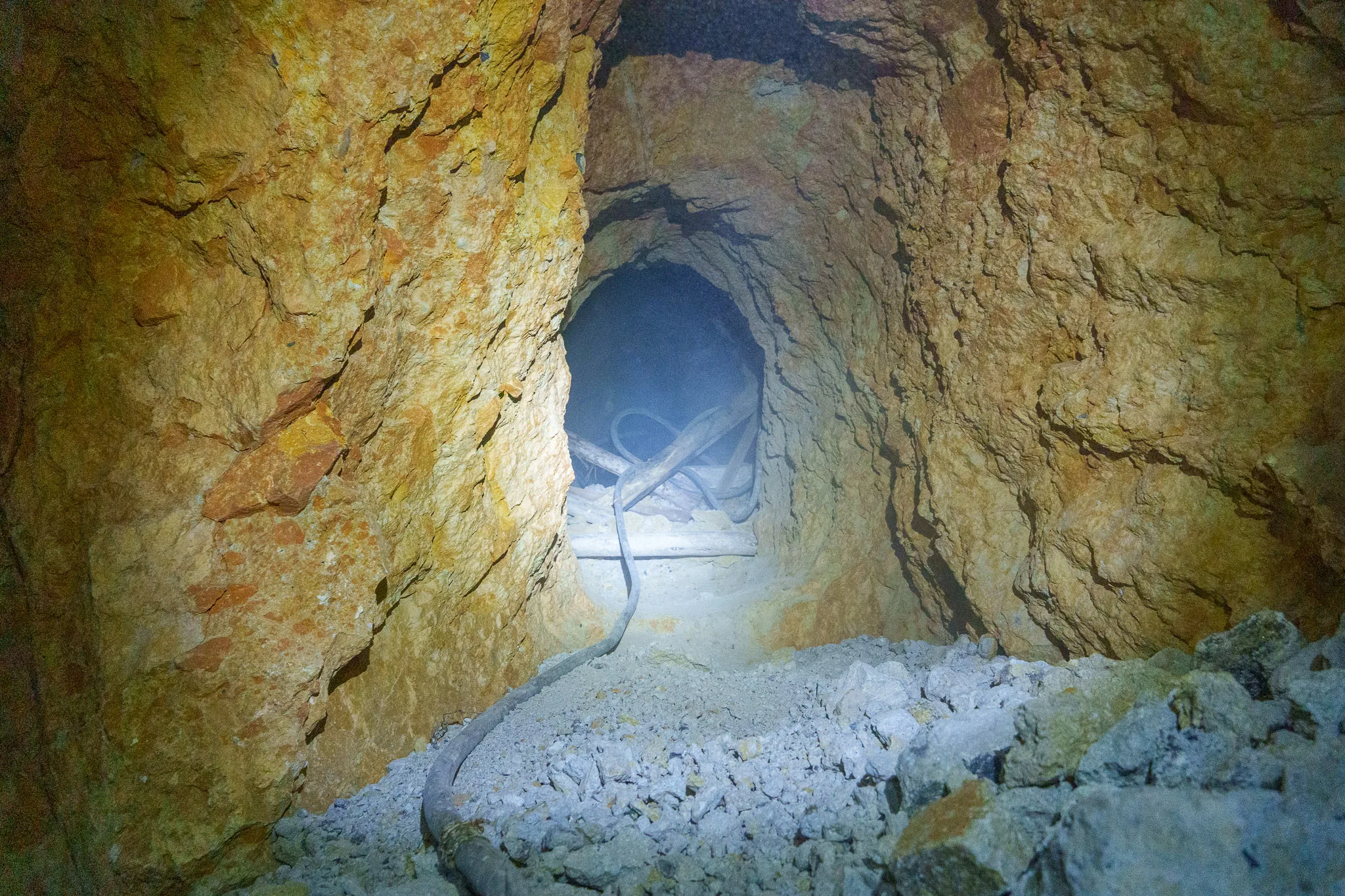 Tunnel inside the Candelaria mine in Potosi. Miners are working with a pneumatic drill, creating a lot of dust. We can't even see them.
