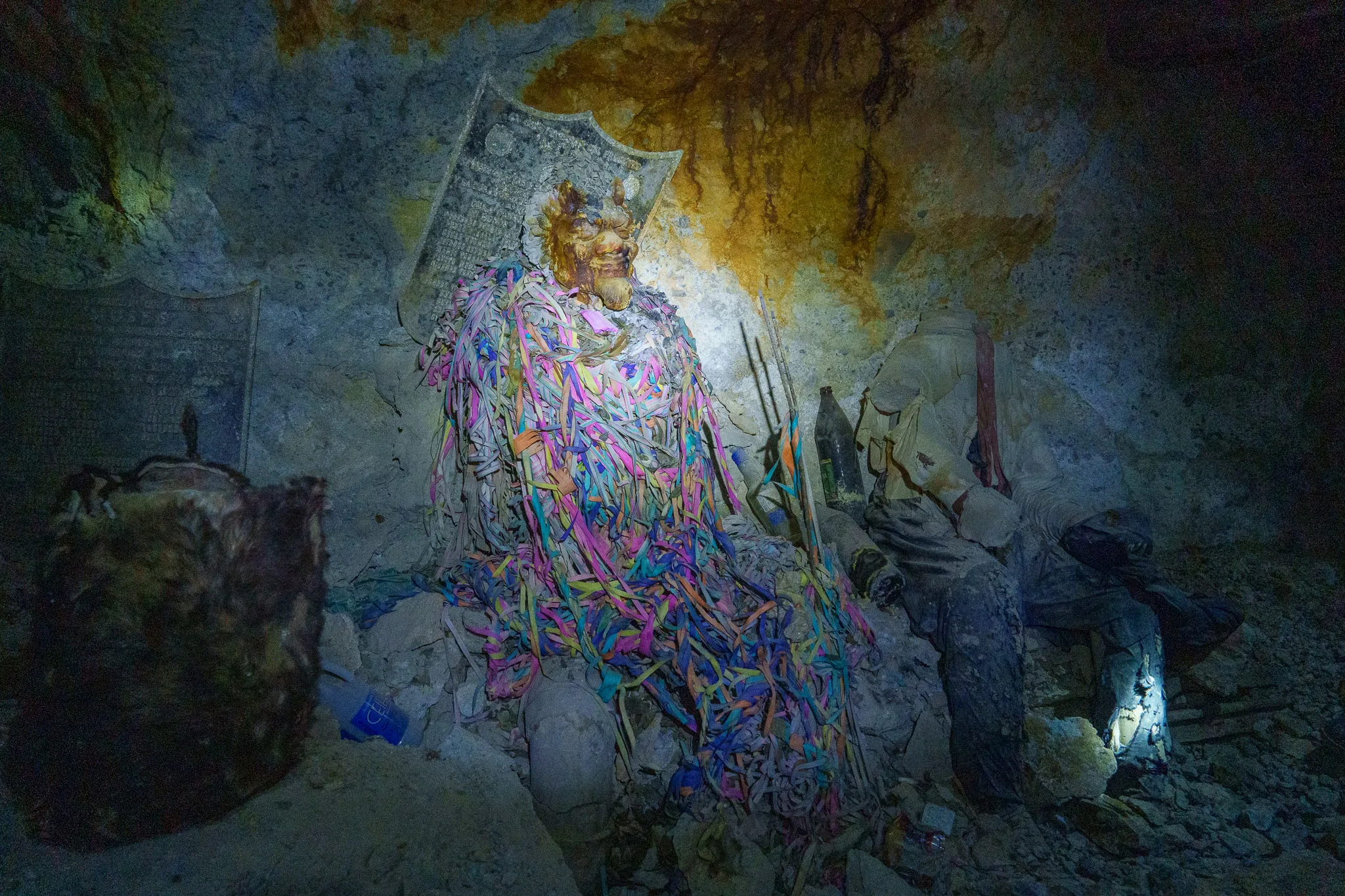 Statue and commemorative plaque inside the Cerro Rico mountain, in the Candelaria mine.
