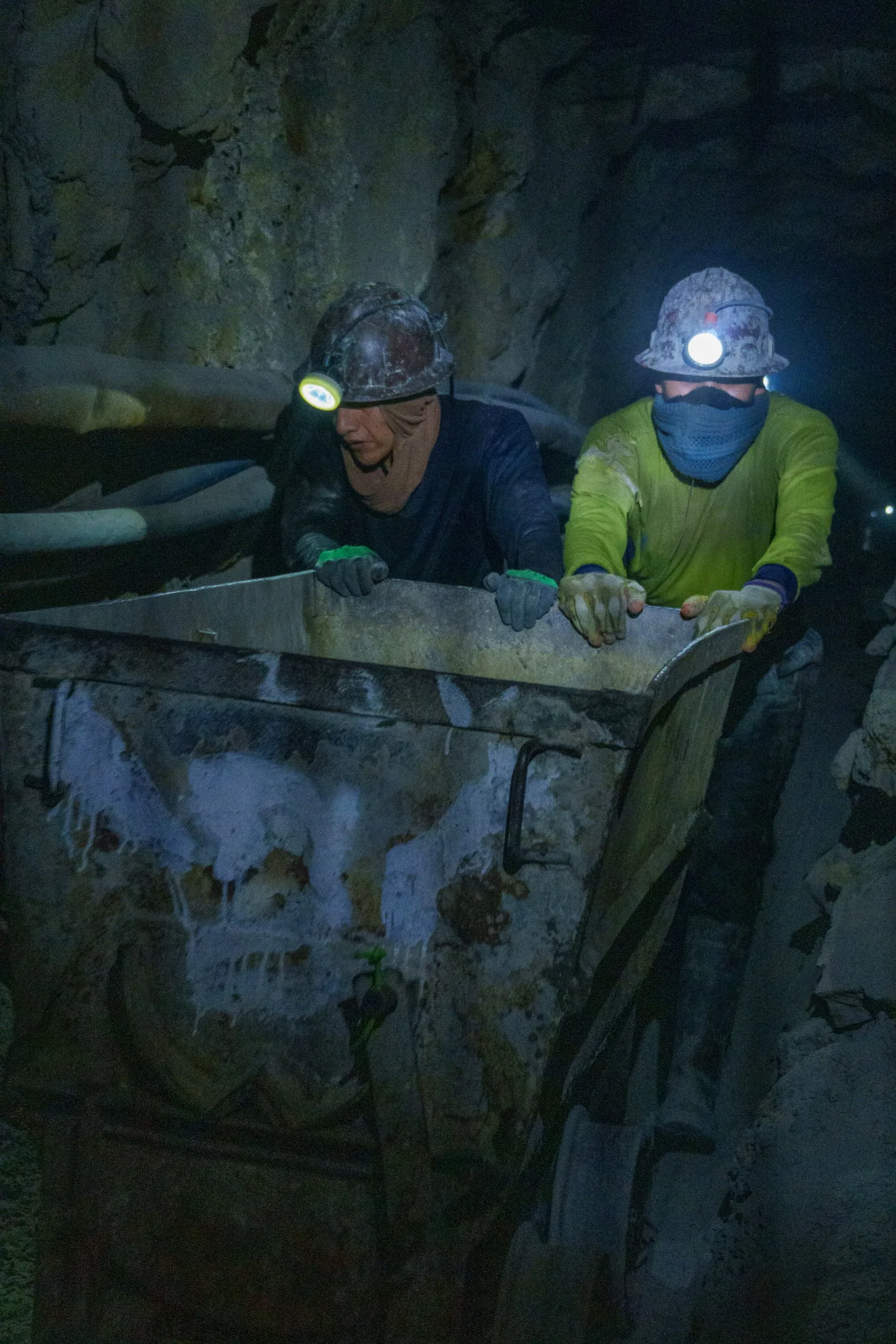miners pushing a mine cart inside Cerro Rico mines in Potosi, Bolivia.