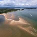 During low tide boats need to do detour to avoid sandbanks. this is in Barra Grande, Marau Brazil.