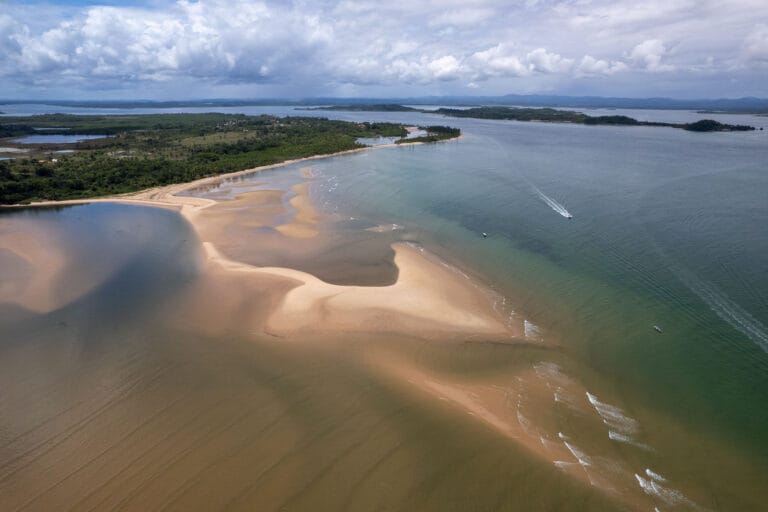 During low tide boats need to do detour to avoid sandbanks. this is in Barra Grande, Marau Brazil.