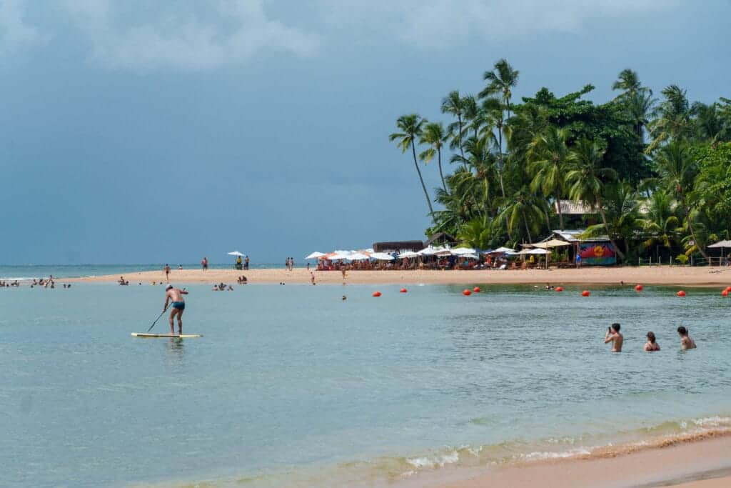 barra grande main beach, Marau brazil. PEople are swimming, doing paddle.