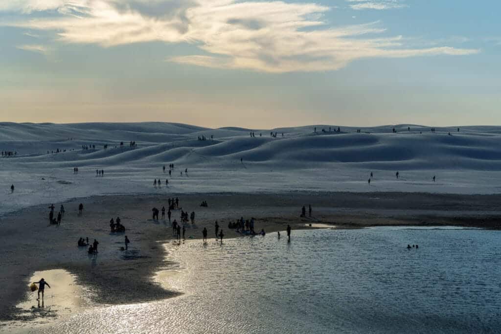 People at lencois maranhense park in january. the lagoons are dry but people still come and take a swim in what's left.