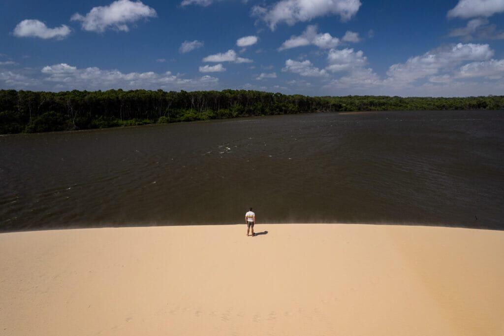 Me (Horizon Hugo) on the top a dune at the Vassouras village during the boat tour on the Preguiças river. We see the river and the jungle in the background