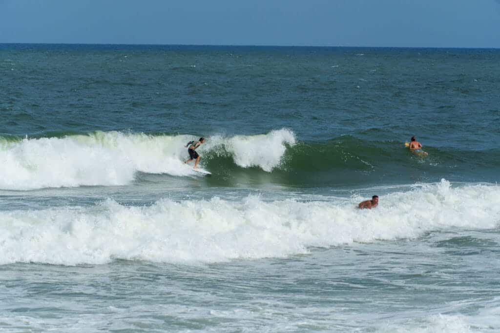 tourist surfing in Tiririca beach in ITacaré Brazil.