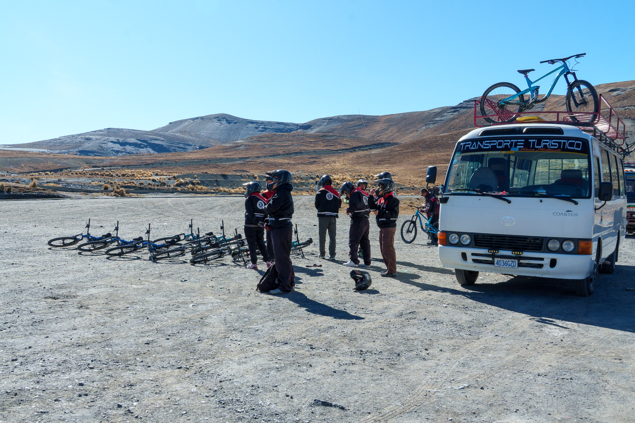 Gravity Bolivia team getting ready at the beginning of the Death Road. Everyone is putting the pants, helmets jacket and more and test their bike.