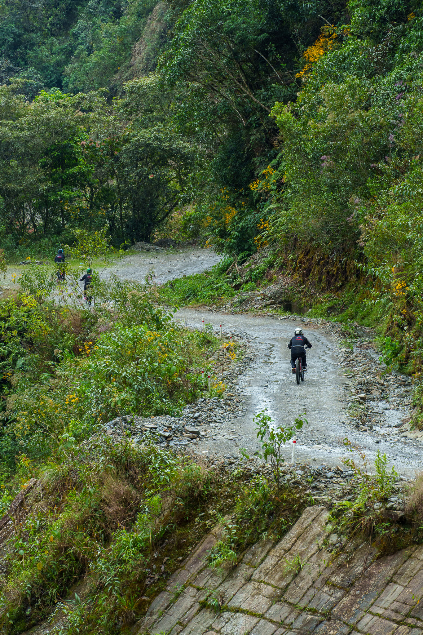 Three people from Gravity Bolivia team is riding down the Death Road.