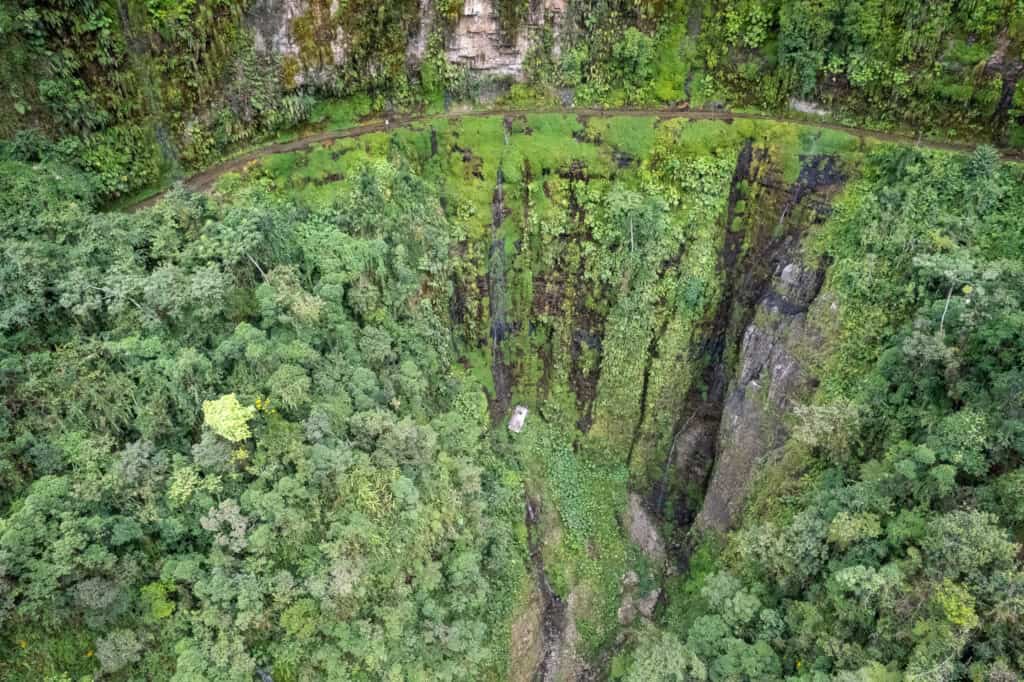 Aerial view of the "Cascada de San Juan", a narrow passage of the Death Road. We can still see a truck at the bottom of the cliff.