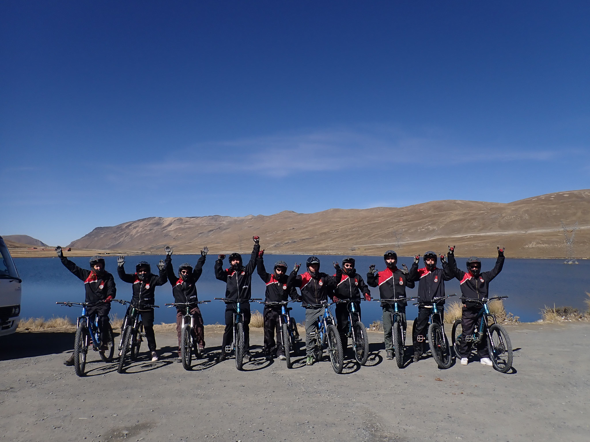 Gravitiy Bolivia team at the beginning of the Death Road Tour in the morning. in the background there is the