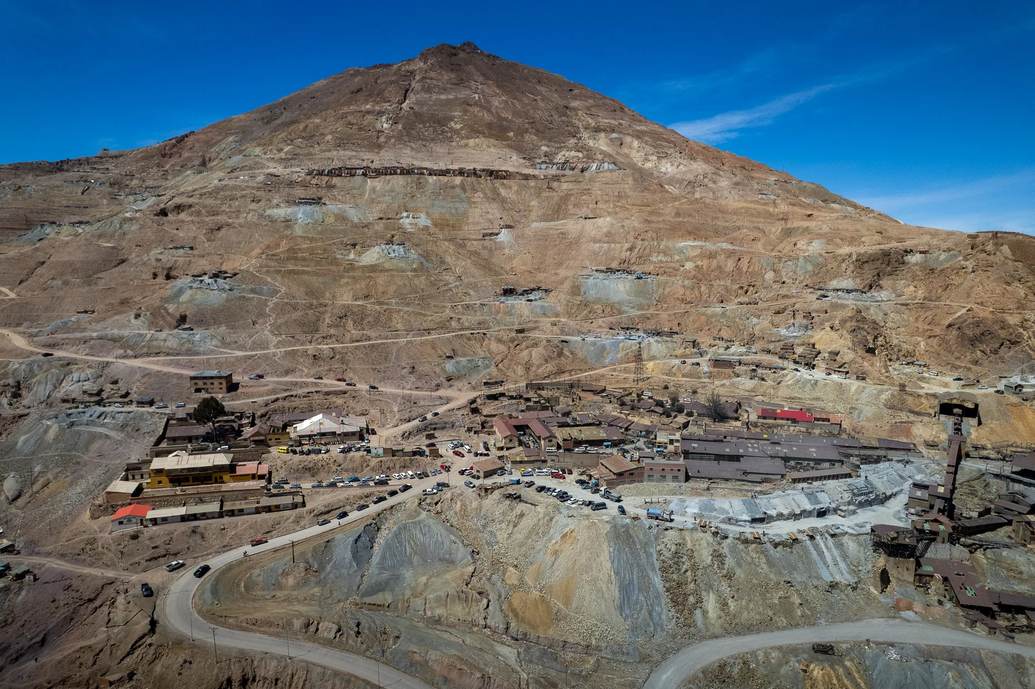 Drone view of the Cerro Rico mountain next to Potosi, Bolivia. We can see trucks, road going nearly to the top of the mountain. Each road leading to an entrance to a mine.
