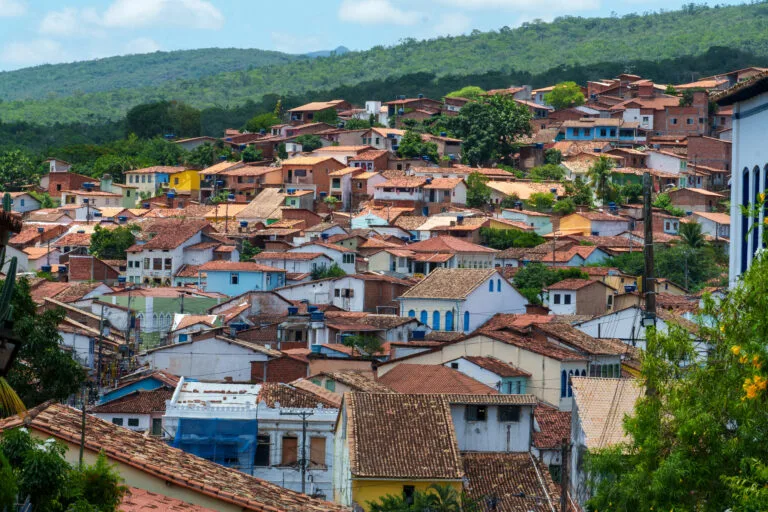 Horizonhugo - Brazil - Lencois Bahia-17 compressed view of houses of lencois in Bahia, Brazil. houses have red tiles and colorful walls. the city is surrounded by forest.