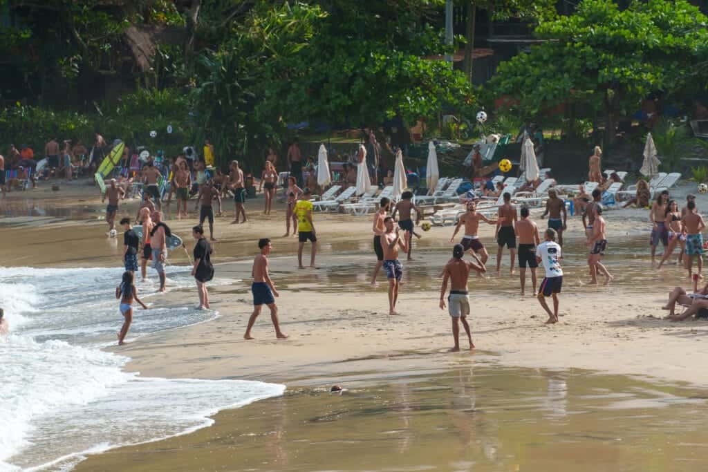 israelis tourists playing football on the beach in Itacaré, Brazil.