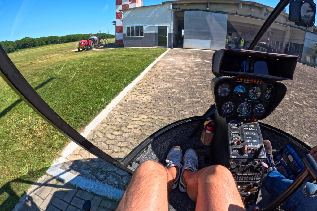 me (horizonhugo) in a front of a 3-seat helicopter, ready to fly over Rio de Janeiro, Brazil